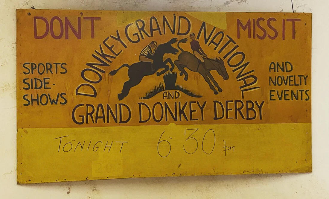 An old painted sign for a donkey grand national